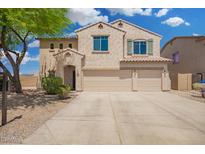 Two-story stucco home with a three car garage and desert landscaping at 5440 W Apollo Rd, Laveen, AZ 85339