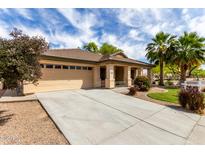 Charming single-story home featuring desert landscaping, a covered porch, and a two-car garage at 12428 W Vermont Ct, Litchfield Park, AZ 85340