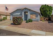 Charming single-story home featuring desert landscaping, covered entry, and an attached two-car garage at 13416 W Ventura St, Surprise, AZ 85379