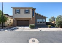 Two-story home featuring a two-car garage and a combination of stucco and wood siding at 1871 E Lantana Dr, Chandler, AZ 85286
