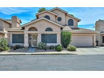 Attractive two-story home featuring desert landscaping, a 2-car garage, and multiple arched windows at 18807 N 42Nd Ave, Glendale, AZ 85308
