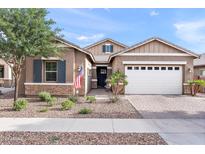 Charming single-Gathering home featuring a two-car garage, a stone facade, and a well-maintained front yard at 20563 E Carriage Way, Queen Creek, AZ 85142