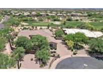 Expansive home with a tile roof is surrounded by mature landscaping and a golf course at 22463 N 54Th St, Phoenix, AZ 85054