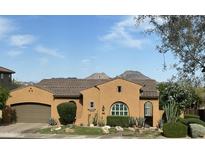 Charming single-story home featuring a well-maintained lawn, desert landscaping, and two car garage at 25943 N 84Th Dr, Peoria, AZ 85383