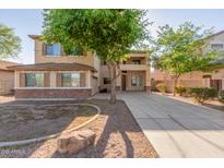 Charming two-story home featuring stucco siding, shutters, and a well-maintained front yard at 3133 N Medallion Ct, Casa Grande, AZ 85122