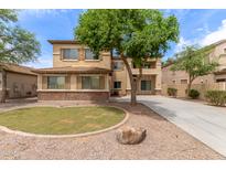 Beautiful two-story home featuring tan stucco, brick accents, and a well-manicured front yard at 3133 N Medallion Ct, Casa Grande, AZ 85122