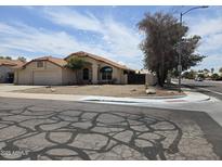 View of single-story home featuring a three-car garage and front yard desert landscaping at 3601 E Taro Ln, Phoenix, AZ 85050