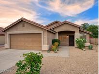 Inviting single-story home featuring a two-car garage and desert landscaping at 3604 W Calle Lejos --, Glendale, AZ 85310