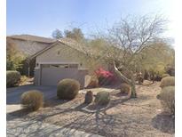 Charming single-story home with desert landscaping, a two-car garage, and neutral color palette at 40713 N Apollo Way, Anthem, AZ 85086