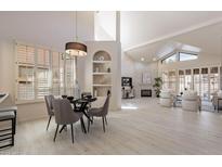 Bright, open living space with vaulted ceilings, a fireplace, and floor-to-ceiling shutters at 4116 E Sunnyside Dr, Phoenix, AZ 85028