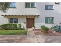 Charming home entrance with a well-manicured lawn and inviting double door at 4248 N Parkway Ave, Scottsdale, AZ 85251