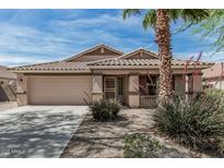 Charming single-story home featuring a tile roof, desert landscaping, and a two-car garage at 708 E Mule Train Trl, San Tan Valley, AZ 85143