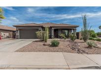 Charming single-story home featuring desert landscaping, a two-car garage, and a covered front porch at 11611 N 149Th Ln, Surprise, AZ 85379