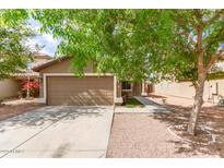 Charming single-story home featuring a well-maintained yard and a two-car garage at 12230 W Larkspur Rd, El Mirage, AZ 85335