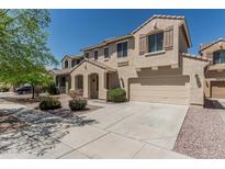 Beautiful two-story home featuring a tile roof, two-car garage, and inviting entryway at 15420 W Canterbury Dr, Surprise, AZ 85379