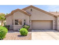 Charming single-story home with a two-car garage, desert landscaping, and a neutral color palette at 1577 E Earl Dr, Casa Grande, AZ 85122