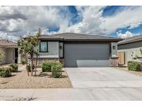Charming single-Gathering home showcases a two-car garage and low-maintenance landscaping for easy living at 17376 W Via De Luna Dr, Surprise, AZ 85387