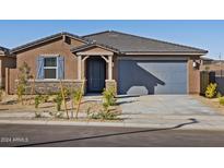 Charming single-story home featuring desert landscaping, blue accents, and a two-car garage at 20368 N 224Th Dr, Surprise, AZ 85387