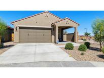 Charming single-story home with a two-car garage, covered entry, and low-maintenance desert landscaping at 21690 N Lynn St, Maricopa, AZ 85138