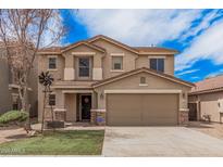 Charming two-story home with a two-car garage, well-kept lawn, and beautiful desert landscaping at 22123 E Vía Del Palo --, Queen Creek, AZ 85142