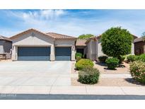 Charming home boasts a well-manicured front yard, complemented by a spacious three-car garage at 2310 W Sienna Bouquet Pl, Phoenix, AZ 85085