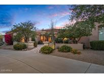 Inviting single-Gathering home showcasing desert landscaping and a warm, tranquil ambiance under the evening sky at 24158 N 78Th Pl, Scottsdale, AZ 85255