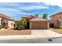 Charming single-story home featuring a tile roof, desert landscaping, and a two-car garage at 2503 E Camellia Dr, Gilbert, AZ 85296