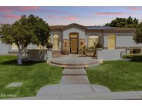 Charming home featuring a well-manicured lawn, inviting walkway, and stone accents at 3410 E Inglewood Cir, Mesa, AZ 85213