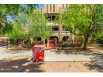 Charming building exterior with well-maintained landscaping and secure gated entry at 387 N 2Nd Ave # F2, Phoenix, AZ 85003