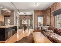 Inviting living space with exposed brick walls, wood floors, and views at 387 N 2Nd Ave # F2, Phoenix, AZ 85003