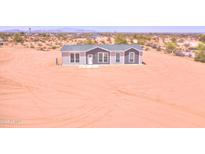 Charming single story home with a gray roof and matching trim in a desert landscape at 51942 W Sotol Rd, Maricopa, AZ 85139