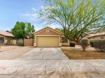 Charming single-story home features a two-car garage and well-maintained front yard at 7037 W Cavalier Dr, Glendale, AZ 85303