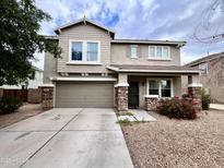 Charming two-story home with a two-car garage, stone accents, and desert landscaping for curb appeal at 7258 W State Ave, Glendale, AZ 85303