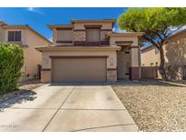 Charming two-story home featuring a two car garage, concrete driveway, and well kept landscaping at 9343 W Quail Ave, Peoria, AZ 85382
