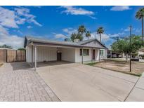 Charming single-story home featuring a covered carport, brick accents and a well-maintained yard at 9609 N 44Th Ave, Glendale, AZ 85302