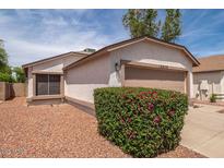 Charming single-story home showcasing a two-car garage and low-maintenance landscaping at 10808 W Ruth Ave, Peoria, AZ 85345