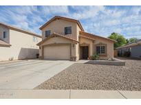 Two-story home featuring a two-car garage and low maintenance desert landscaping at 12513 W Dreyfus Dr, El Mirage, AZ 85335