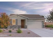 Charming single-Gathering home boasting stone accents, a neutral color palette, and a well-manicured front yard at 12576 W Trumbull Rd, Avondale, AZ 85323