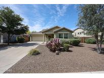 Charming single-story home with desert landscaping and a two-car garage at 12845 W Milton Dr, Peoria, AZ 85383