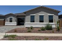 Charming single-story home showcasing a well-manicured front yard with desert landscaping and a neutral-toned facade at 16494 W Creedance Blvd, Surprise, AZ 85387