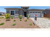 Charming single-story home featuring stone accents and a well-maintained front yard at 16550 W Creedance Blvd, Surprise, AZ 85387