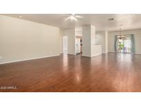 Spacious living room with hardwood floors, ceiling fan, and sliding glass doors at 16848 W Rimrock St, Surprise, AZ 85388