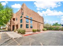 Attractive two-story stucco building with large windows, landscaping, and assigned parking spots at 1718 W Colter St # 195, Phoenix, AZ 85015