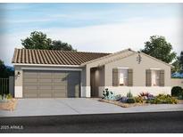 Charming single-story home featuring a two-car garage, desert landscaping, and a tile roof at 17715 W Ford St, Goodyear, AZ 85338
