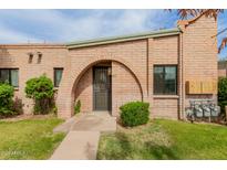Charming brick home featuring a unique arched entryway and well-maintained front yard at 4401 E Hubbell St # 57, Phoenix, AZ 85008