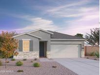 Charming single-story home with a neutral color palette, stone accents, and a well-manicured front yard at 4417 S 126Th Ave, Avondale, AZ 85323