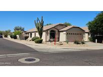 Charming single-story home with desert landscaping, neutral colors, and a two-car garage at 4721 E Abraham Ln, Phoenix, AZ 85050