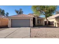 Charming single-story home with a two-car garage and low-maintenance desert landscaping, featuring a beautiful blue sky at 6784 W Gardenia Ave, Glendale, AZ 85303