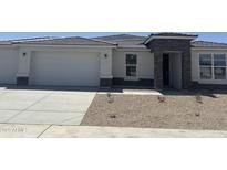 Beautiful single-story home featuring stone accents, a two-car garage, and low-maintenance desert landscaping at 17747 W Brown St, Waddell, AZ 85355