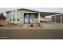 Well-maintained home features a covered parking area and desert landscaping, offering both convenience and curb appeal at 1820 N Thornton Rd # 917, Casa Grande, AZ 85122